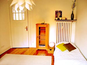 Room view toward the door, bed