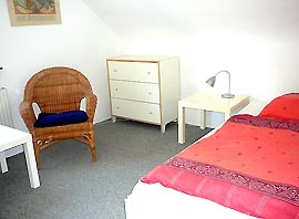 Single room with wicker chair