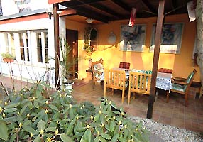 seating corner with view into the garden of the holiday house