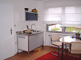 table and small kitchen in your room in Cologne 