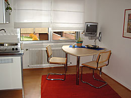 table and small kitchen in your room in Cologne