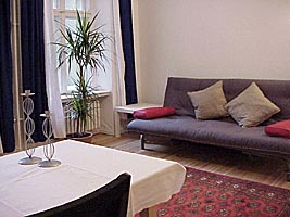 Living room with a TV set and sleeping, sofa in the holiday apartment in Berlin Charlottenburg