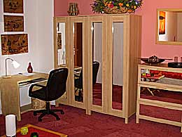 Desk and cabinets in a room with a balcony