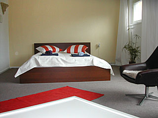 big double bed in the room of the apartment in Gleimstrasse