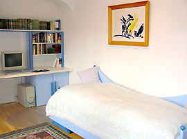 Bed, table with shelves and computer