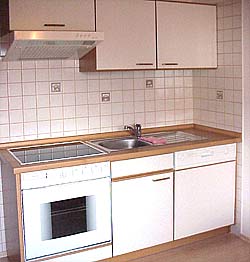 Kitchen with seating area, view into the garden, kettle, coffee machine, cooker and crockery you will need for your stay 